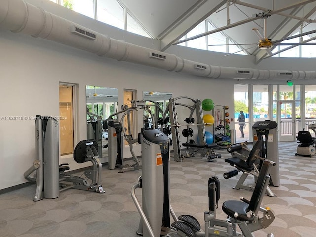 2500 Parkview Dr Unit 1717, Hallandale Beach, FL 33009 - gym with high vaulted ceiling, carpet, and plenty of natural light