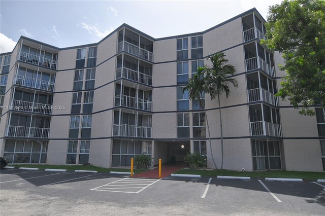 7125 NW 186th St Unit B311, Hialeah, FL 33015 - view of apartment building / complex featuring uncovered parking