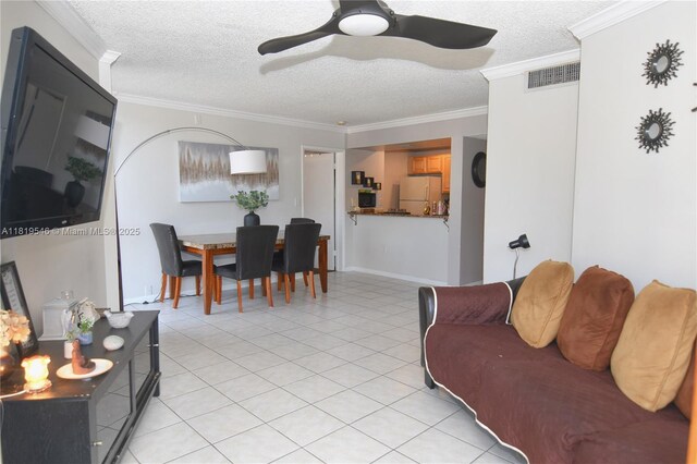 7125 NW 186th St Unit B311, Hialeah, FL 33015 - living area featuring a textured ceiling, a ceiling fan, and ornamental molding