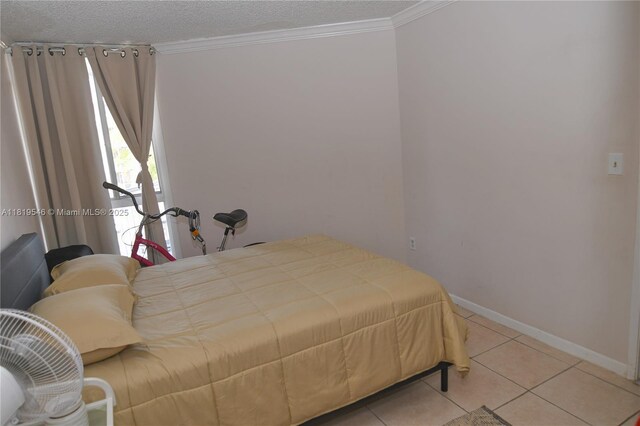 7125 NW 186th St Unit B311, Hialeah, FL 33015 - bedroom with crown molding, a textured ceiling, and tile patterned flooring