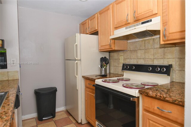 7125 NW 186th St Unit B311, Hialeah, FL 33015 - kitchen with electric range, under cabinet range hood, light tile patterned flooring, dark stone countertops, and backsplash