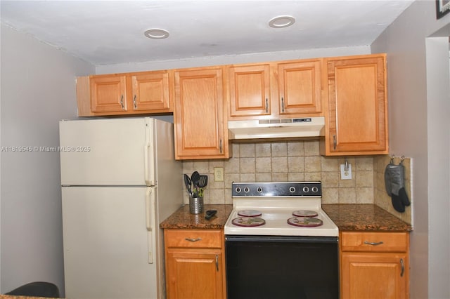 7125 NW 186th St Unit B311, Hialeah, FL 33015 - kitchen with under cabinet range hood, electric range oven, freestanding refrigerator, backsplash, and dark stone counters