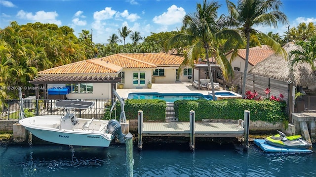 2085 Ixora Rd, North Miami, FL 33181 - rear view of property with a tiled roof, a patio, stucco siding, and a water view