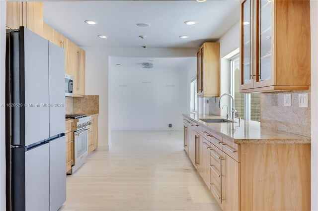 2085 Ixora Rd, North Miami, FL 33181 - kitchen with appliances with stainless steel finishes, recessed lighting, backsplash, light stone countertops, and glass insert cabinets