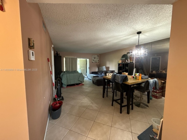 2900 Fiore Way Unit 1080, Delray Beach, FL 33445 - dining space with light tile patterned floors, a textured ceiling, and a chandelier