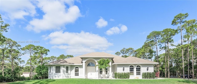 17038 N 61st Pl N, Loxahatchee, FL 33470 - mediterranean / spanish-style home featuring a front lawn and stucco siding