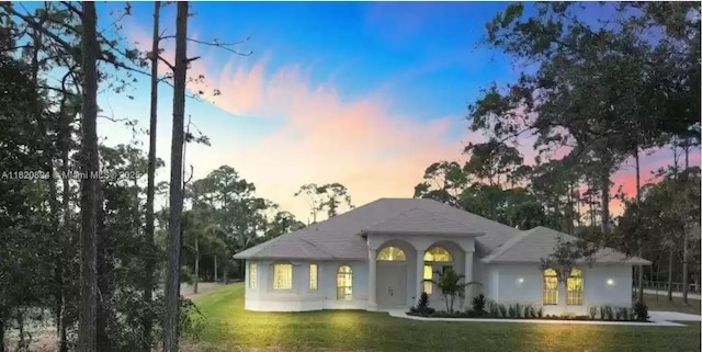 17038 N 61st Pl N, Loxahatchee, FL 33470 - view of front of property with a front yard and stucco siding
