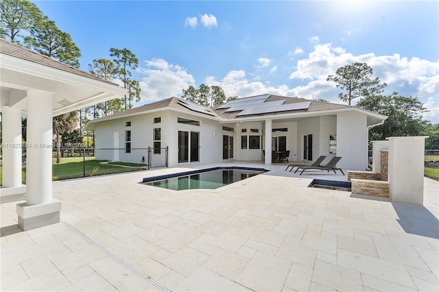 17038 N 61st Pl N, Loxahatchee, FL 33470 - rear view of property featuring a patio area, solar panels, stucco siding, an outdoor pool, and roof with shingles