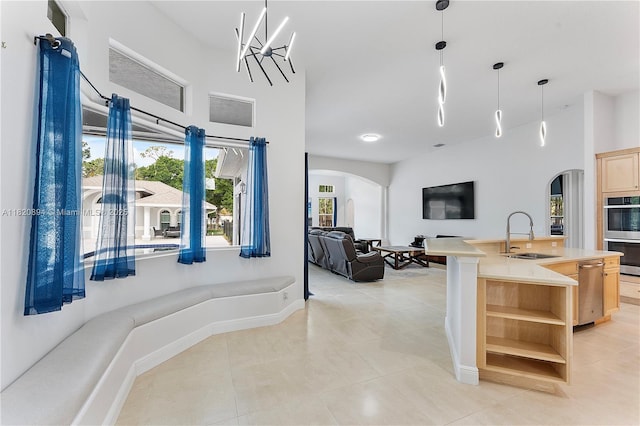 17038 N 61st Pl N, Loxahatchee, FL 33470 - kitchen featuring arched walkways, light brown cabinetry, open shelves, open floor plan, and stainless steel appliances