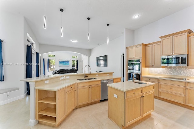 17038 N 61st Pl N, Loxahatchee, FL 33470 - kitchen featuring appliances with stainless steel finishes, light brown cabinetry, an island with sink, arched walkways, and recessed lighting