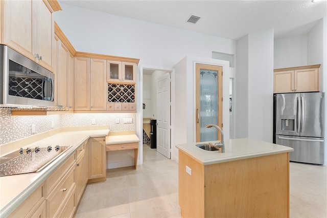 17038 N 61st Pl N, Loxahatchee, FL 33470 - kitchen featuring stainless steel appliances, light brown cabinetry, tasteful backsplash, and an island with sink