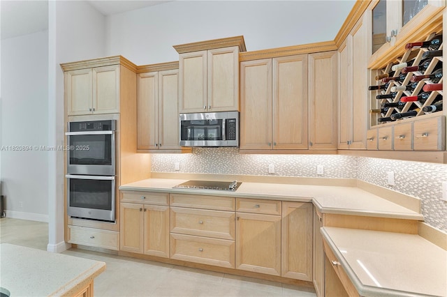 17038 N 61st Pl N, Loxahatchee, FL 33470 - kitchen with stainless steel appliances, light brown cabinetry, tasteful backsplash, and light countertops