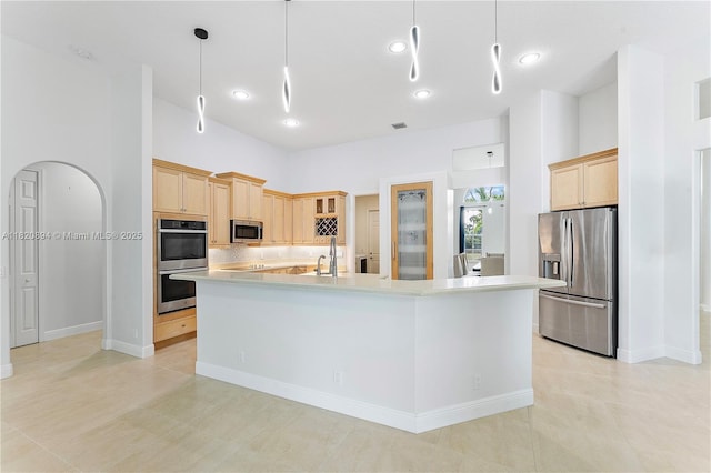 17038 N 61st Pl N, Loxahatchee, FL 33470 - kitchen with stainless steel appliances, light brown cabinets, backsplash, light countertops, and a spacious island