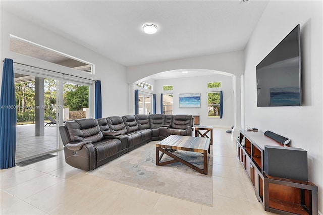 17038 N 61st Pl N, Loxahatchee, FL 33470 - living area with arched walkways, healthy amount of natural light, light tile patterned floors, and french doors