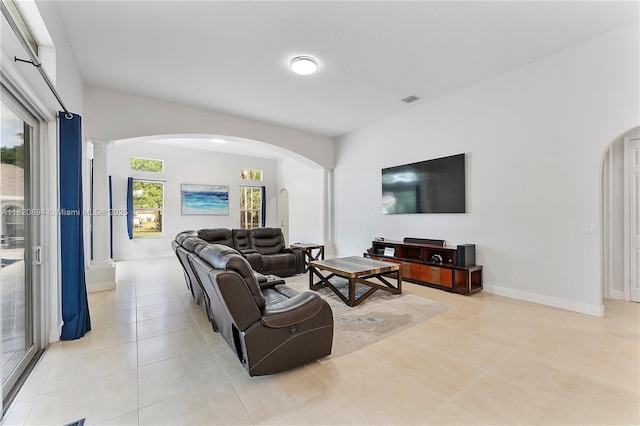 17038 N 61st Pl N, Loxahatchee, FL 33470 - living room featuring arched walkways, decorative columns, and light tile patterned floors