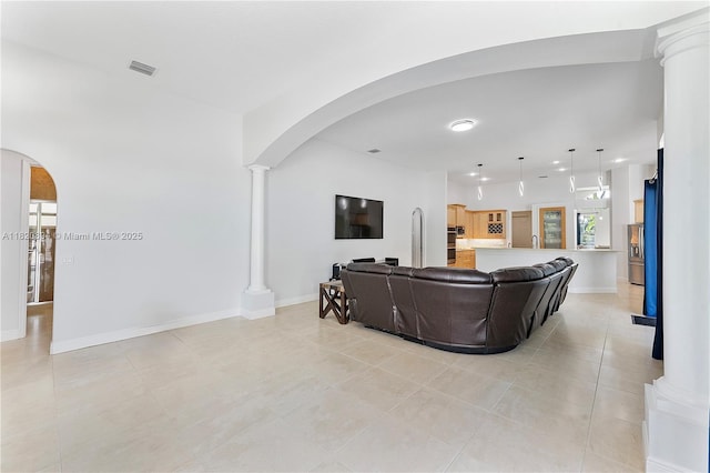 17038 N 61st Pl N, Loxahatchee, FL 33470 - living area with ornate columns, light tile patterned floors, arched walkways, and recessed lighting