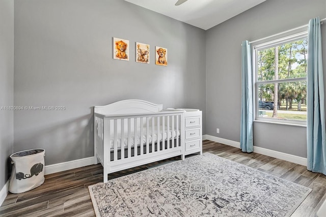 17038 N 61st Pl N, Loxahatchee, FL 33470 - bedroom with a nursery area, wood finished floors, and a ceiling fan