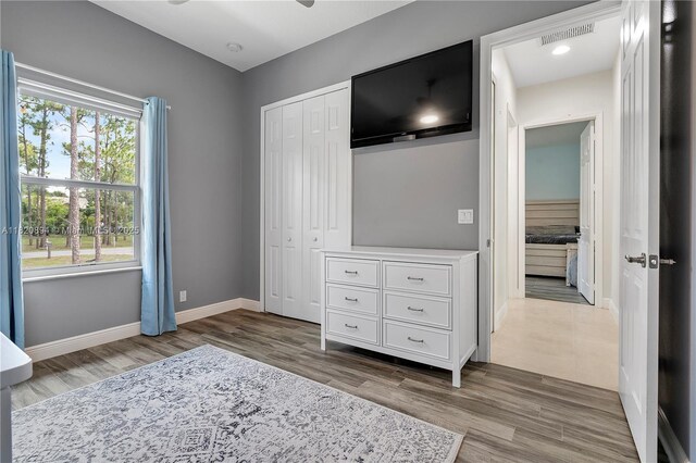 17038 N 61st Pl N, Loxahatchee, FL 33470 - unfurnished bedroom with wood finished floors and a closet