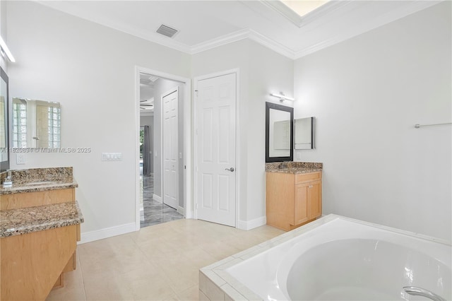 17038 N 61st Pl N, Loxahatchee, FL 33470 - bathroom with a garden tub, crown molding, two vanities, and tile patterned flooring