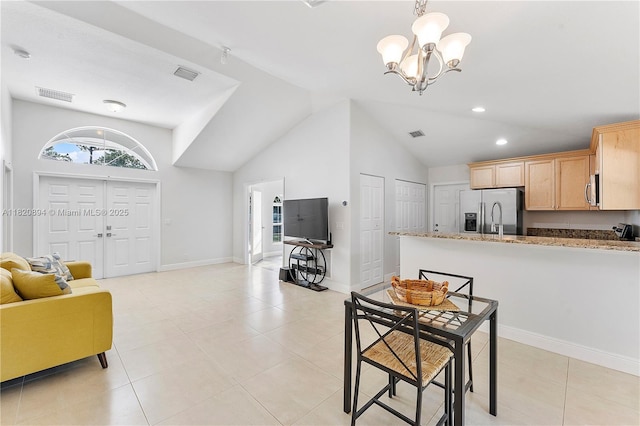 17038 N 61st Pl N, Loxahatchee, FL 33470 - kitchen with appliances with stainless steel finishes, a chandelier, lofted ceiling, open floor plan, and light brown cabinetry