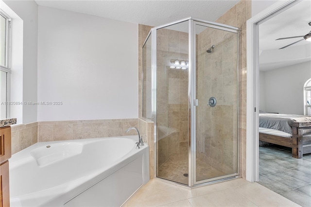 17038 N 61st Pl N, Loxahatchee, FL 33470 - ensuite bathroom with a bath, a stall shower, tile patterned floors, and a ceiling fan