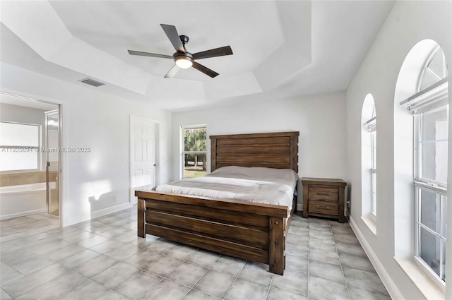 17038 N 61st Pl N, Loxahatchee, FL 33470 - bedroom with a tray ceiling, ensuite bathroom, and a ceiling fan