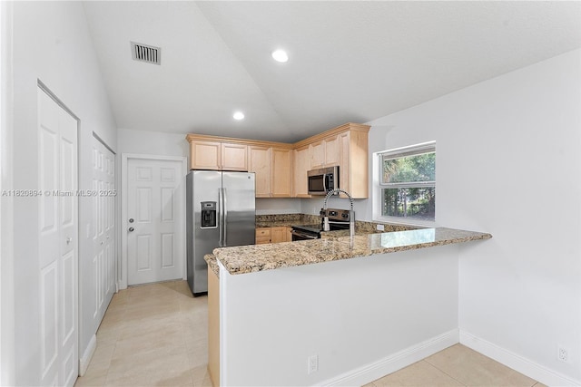 17038 N 61st Pl N, Loxahatchee, FL 33470 - kitchen featuring appliances with stainless steel finishes, lofted ceiling, light brown cabinets, a peninsula, and light stone counters