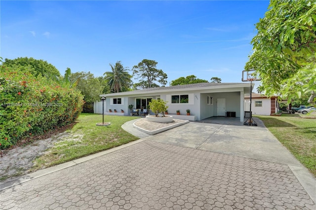 651 E Evanston Cir, Fort Lauderdale, FL 33312 - ranch-style house with a front lawn, driveway, stucco siding, and an attached carport
