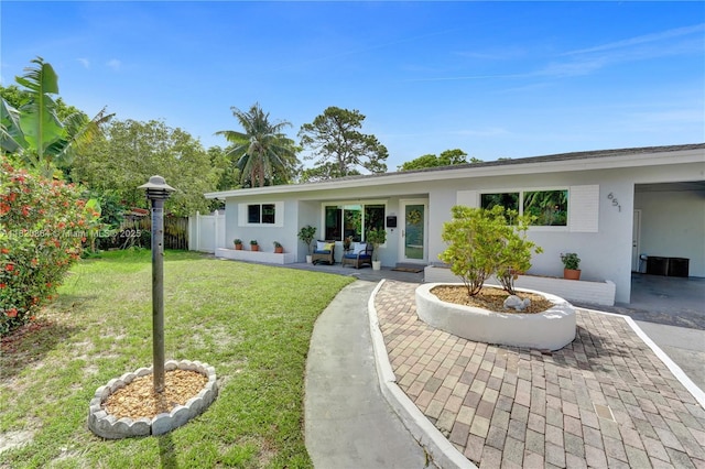 651 E Evanston Cir, Fort Lauderdale, FL 33312 - rear view of property featuring a lawn, stucco siding, outdoor lounge area, and a patio area