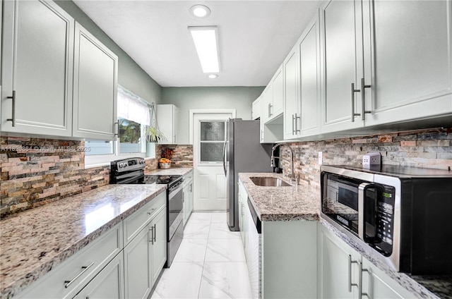 651 E Evanston Cir, Fort Lauderdale, FL 33312 - kitchen featuring stainless steel appliances, light stone counters, decorative backsplash, light marble finish floors, and recessed lighting