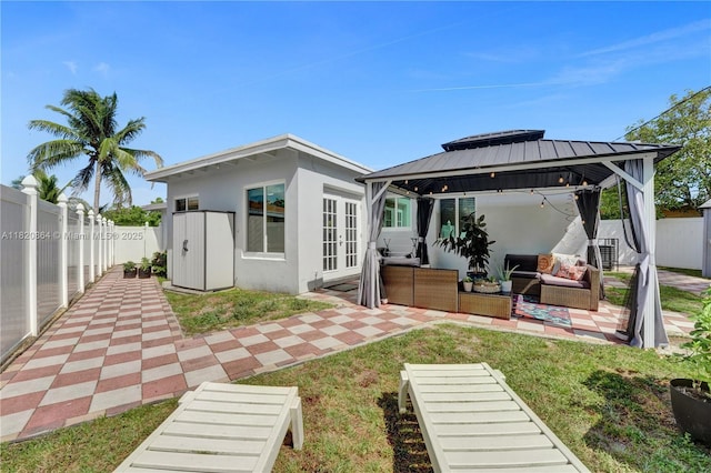 651 E Evanston Cir, Fort Lauderdale, FL 33312 - rear view of house featuring french doors, a gazebo, an outdoor living space, stucco siding, and a fenced backyard