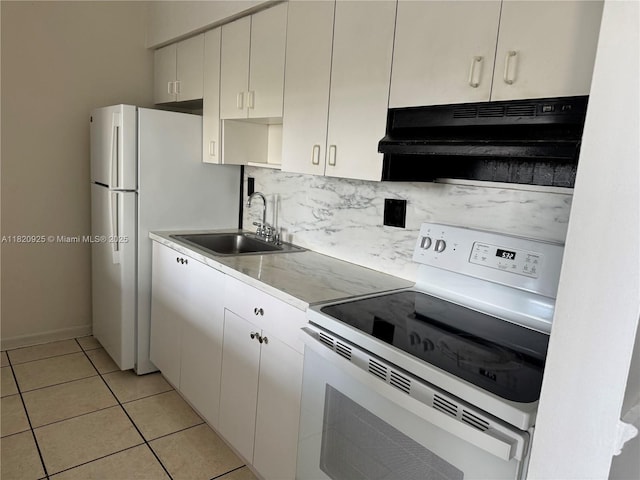 7400 W 20th Ave Unit 416, Hialeah, FL 33016 - kitchen with white appliances, under cabinet range hood, light countertops, decorative backsplash, and light tile patterned floors