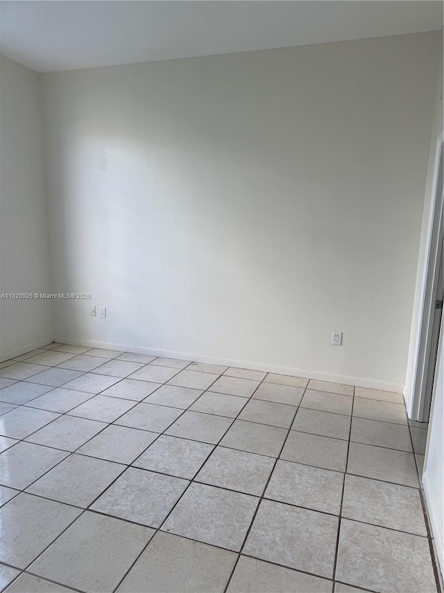 7400 W 20th Ave Unit 416, Hialeah, FL 33016 - spare room featuring light tile patterned floors and baseboards