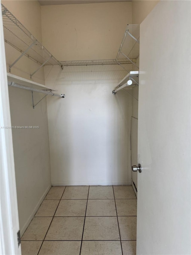 7400 W 20th Ave Unit 416, Hialeah, FL 33016 - spacious closet featuring light tile patterned floors