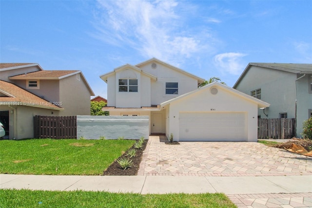 9741 SW 12th St, Pembroke Pines, FL 33025 - traditional home with an attached garage, decorative driveway, and stucco siding