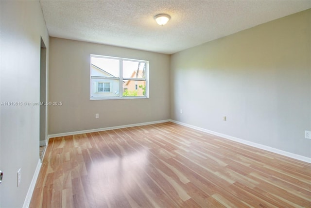 9741 SW 12th St, Pembroke Pines, FL 33025 - empty room with light wood-style flooring and a textured ceiling