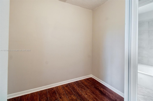 9741 SW 12th St, Pembroke Pines, FL 33025 - empty room with dark wood-style floors and a textured ceiling