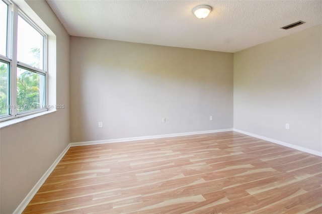 9741 SW 12th St, Pembroke Pines, FL 33025 - unfurnished room with light wood-style floors and a textured ceiling