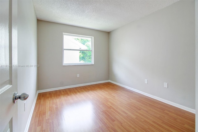 9741 SW 12th St, Pembroke Pines, FL 33025 - empty room featuring light wood finished floors and a textured ceiling