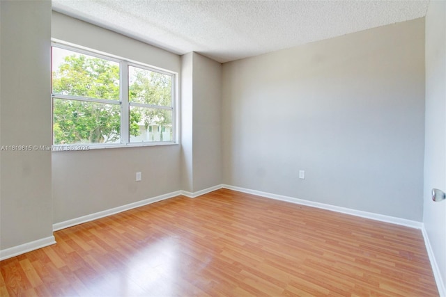 9741 SW 12th St, Pembroke Pines, FL 33025 - spare room with light wood-type flooring and a textured ceiling