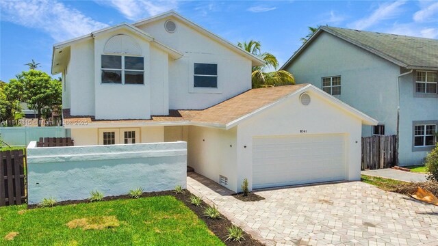 9741 SW 12th St, Pembroke Pines, FL 33025 - view of front of house featuring stucco siding, a garage, and driveway