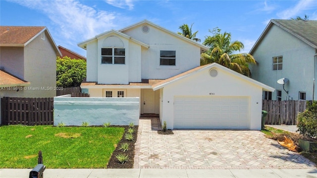9741 SW 12th St, Pembroke Pines, FL 33025 - view of front facade featuring a garage, stucco siding, and driveway