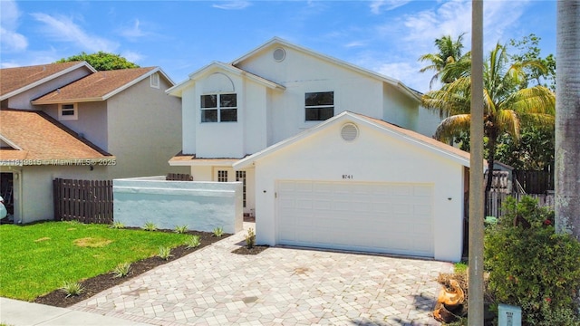 9741 SW 12th St, Pembroke Pines, FL 33025 - view of front of house with stucco siding, a garage, and decorative driveway