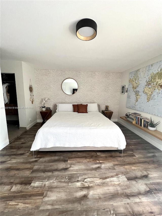 3003 Deer Creek Lake Shore Dr Unit 3003, Deerfield Beach, FL 33442 - bedroom featuring wood finished floors, an accent wall, and brick wall