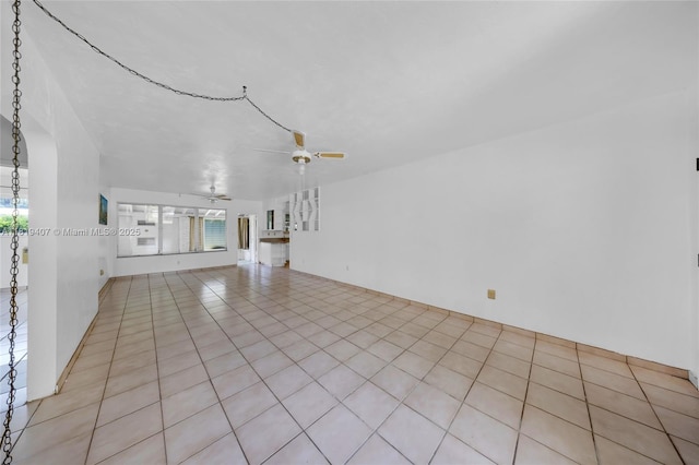 810 NE 119th St, Biscayne Park, FL 33161 - empty room featuring ceiling fan, healthy amount of natural light, and light tile patterned flooring