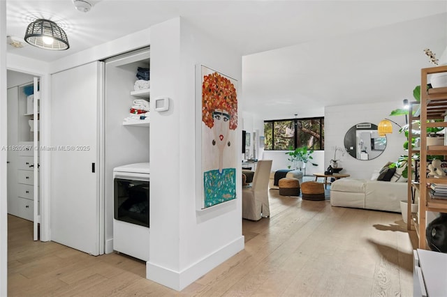 141 Crandon Blvd Unit 237, Key Biscayne, FL 33149 - hall with washer / clothes dryer and light wood-style flooring
