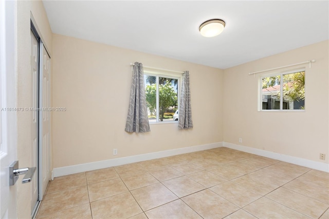 918 NE 6th St, Hallandale Beach, FL 33009 - empty room with healthy amount of natural light and light tile patterned floors
