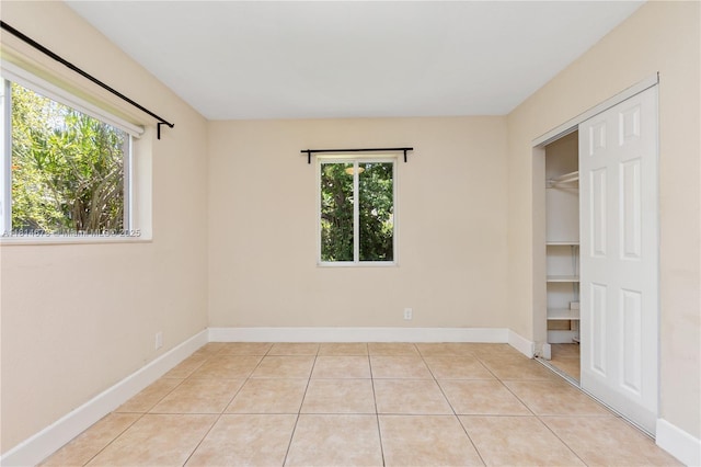 918 NE 6th St, Hallandale Beach, FL 33009 - unfurnished bedroom featuring light tile patterned flooring and a closet