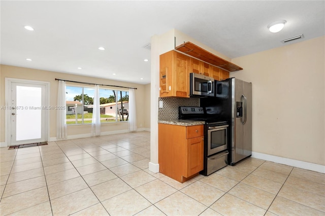 918 NE 6th St, Hallandale Beach, FL 33009 - kitchen with appliances with stainless steel finishes, light tile patterned floors, brown cabinetry, decorative backsplash, and recessed lighting