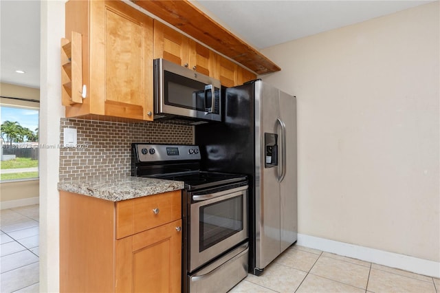 918 NE 6th St, Hallandale Beach, FL 33009 - kitchen featuring stainless steel appliances, light tile patterned floors, backsplash, and light stone counters